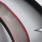 Close-up of a sleek car interior trim featuring a matte grey finish with a vibrant red accent line.