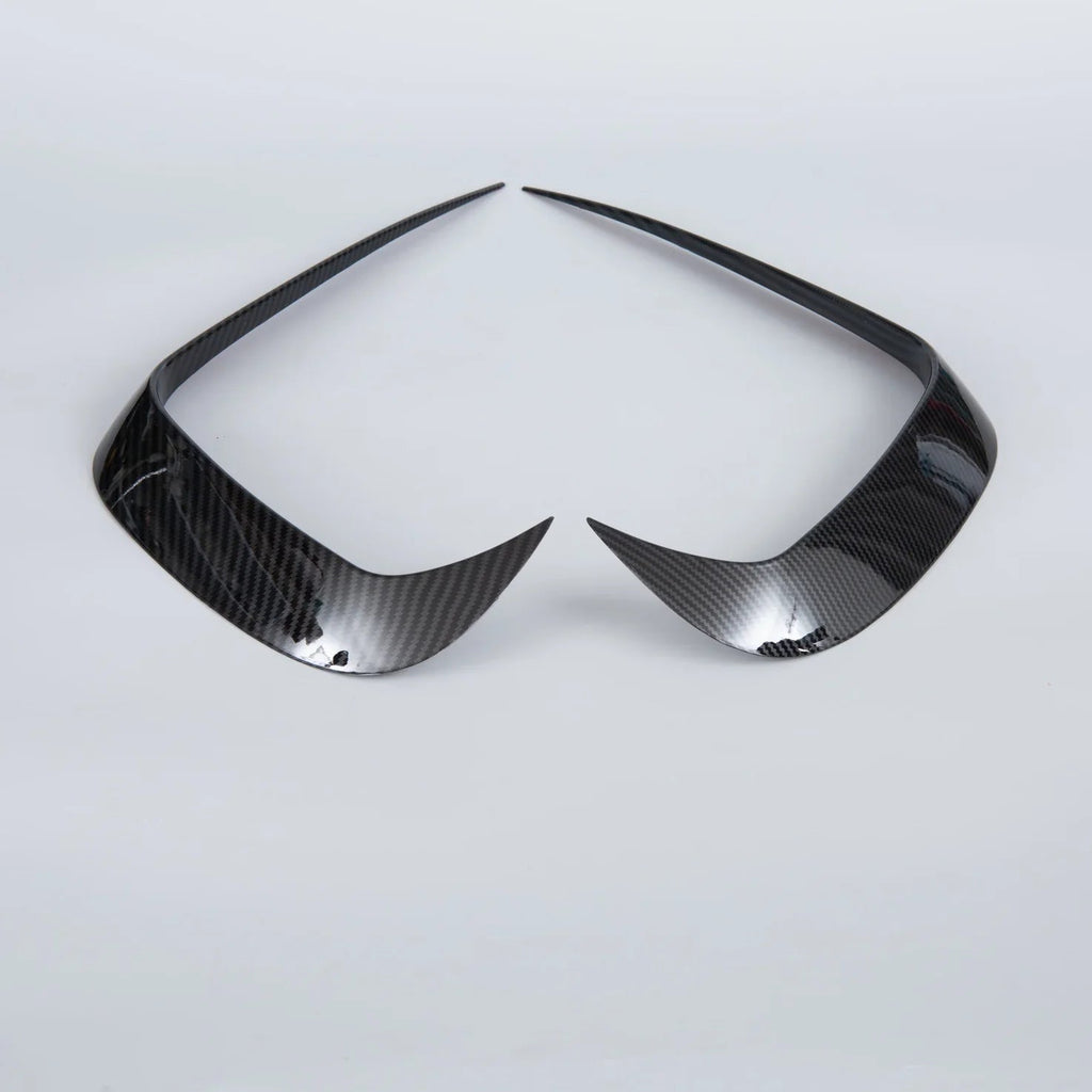 Pair of professional carbon fiber headlight covers in glossy black for BYD car accessories.