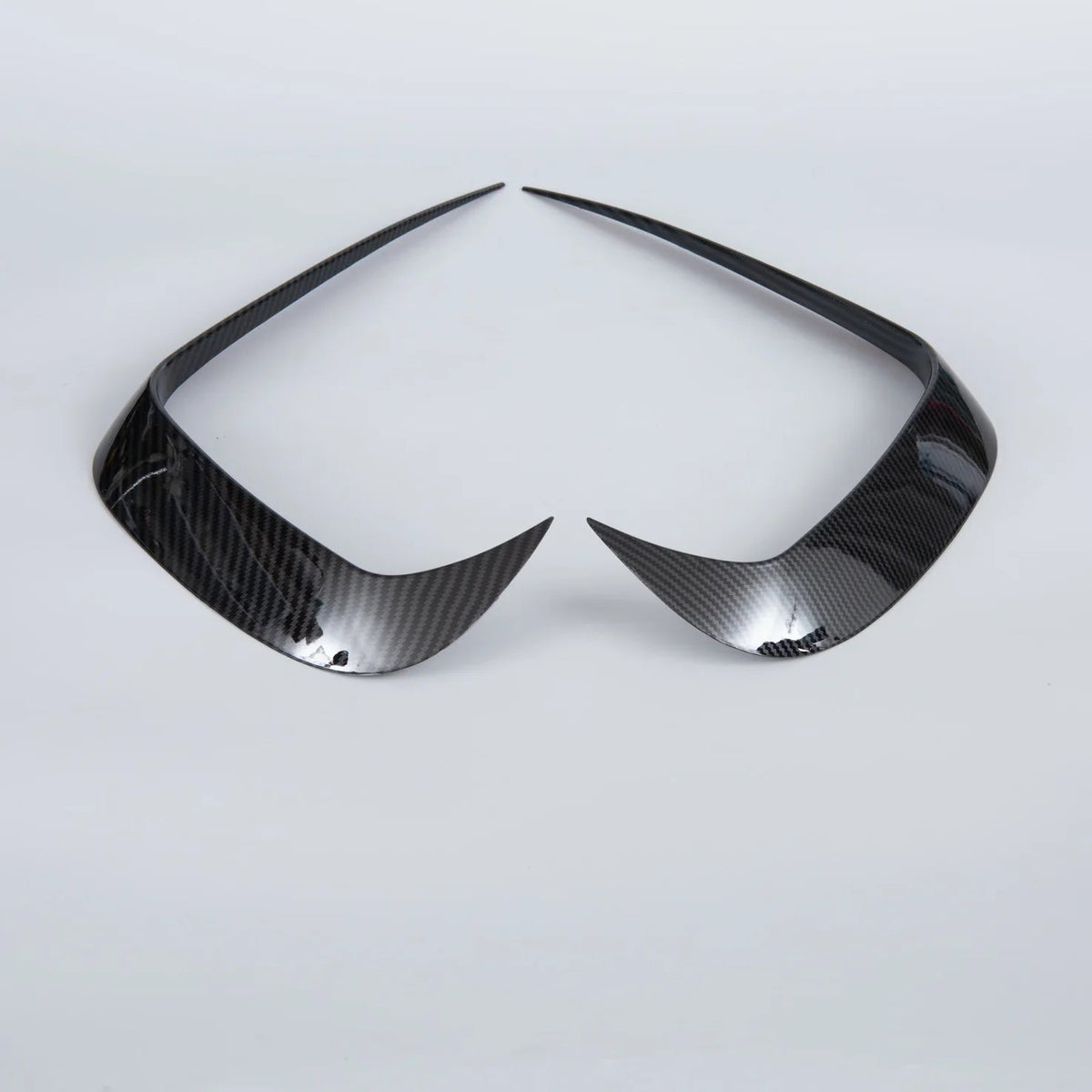 Pair of professional carbon fiber headlight covers in glossy black for BYD car accessories.