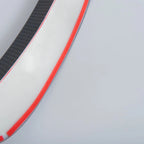 Close-up of a white automotive trim piece with red accents and carbon fiber texture.