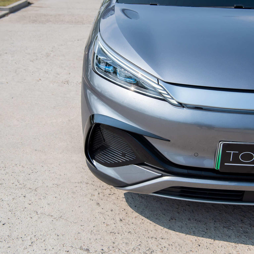 Close-up of a sleek grey BYD car featuring modern LED headlights and a black front grille.