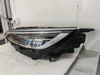 Sleek black LED headlight assembly with clear lens and chrome internal housing components.