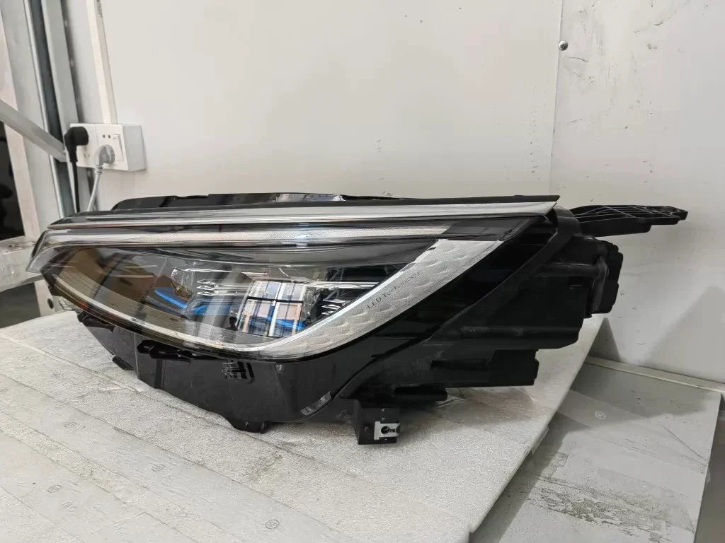 Sleek black LED headlight assembly with clear lens and chrome internal housing components.