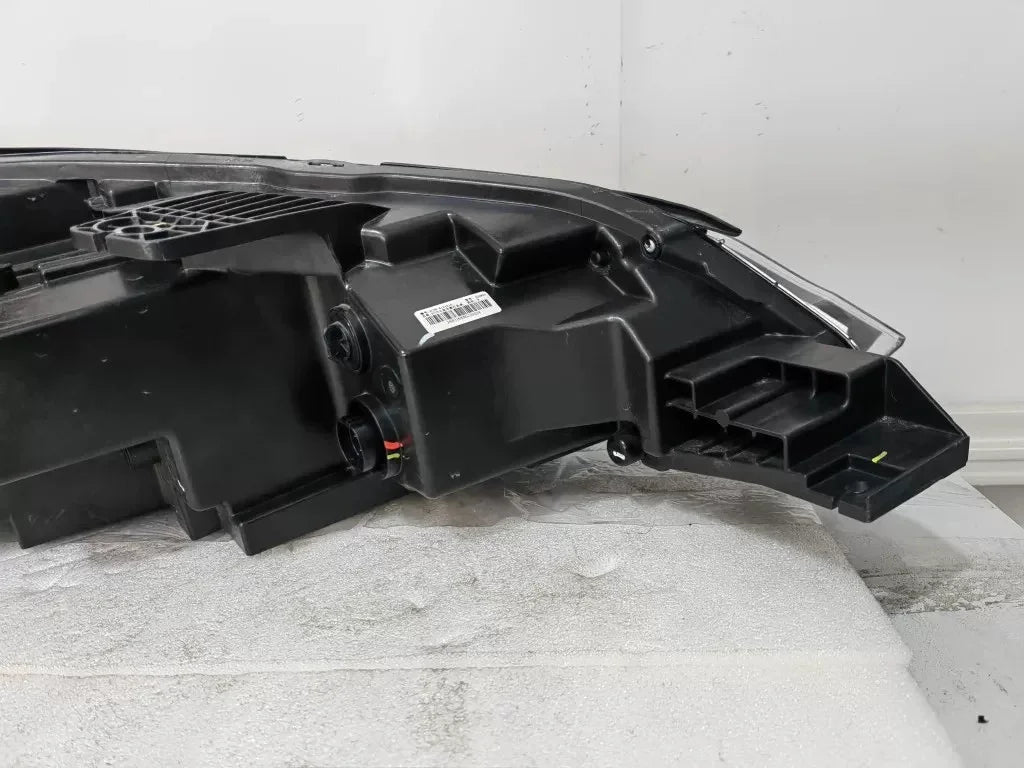 Black durable plastic automotive headlight assembly housing for BYD vehicles.