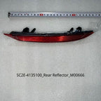 Red plastic rear bumper reflector for BYD vehicles, displayed with a measuring tape.