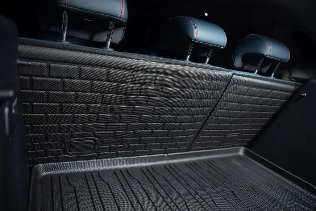 Black heavy-duty textured rubber cargo mat and matching backrest protectors for car interior protection.