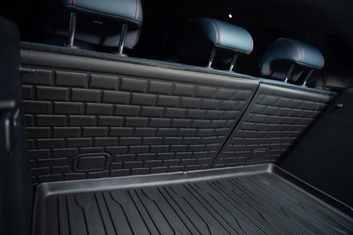 Black heavy-duty textured rubber cargo mat and matching backrest protectors for car interior protection.