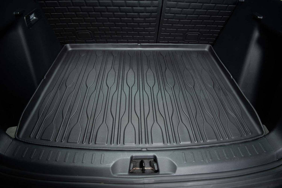 Black heavy-duty TPE rubber trunk mat with anti-slip textured grooves for car cargo protection.