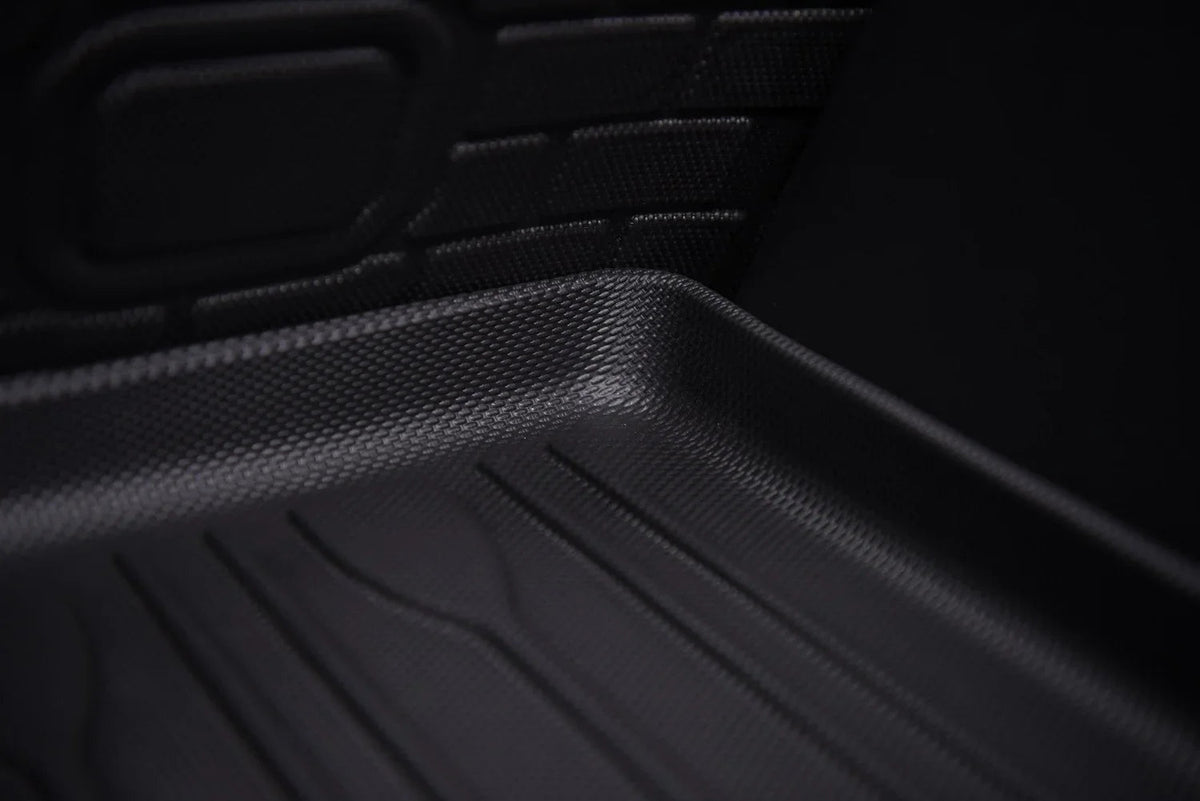 Black textured TPE car floor mat with anti-slip grooves for durable protection.