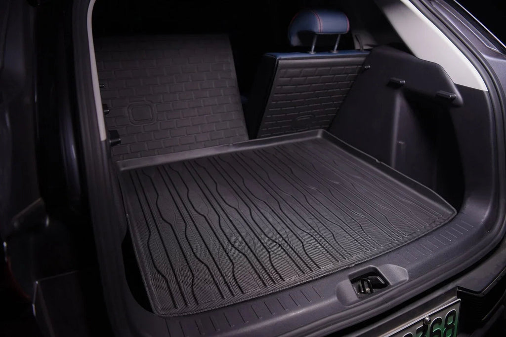 Black heavy-duty rubber cargo mat installed in the trunk of a BYD vehicle for spill protection.