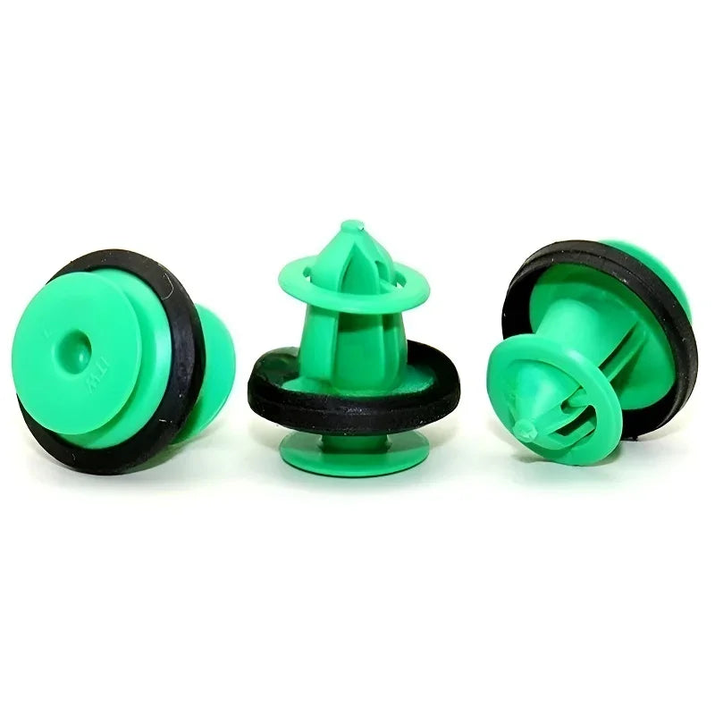 Three green plastic irrigation sprinkler heads with black rubber gaskets on a white background.