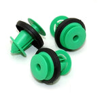 Three green plastic automotive trim clips with black rubber gaskets for secure fastening.