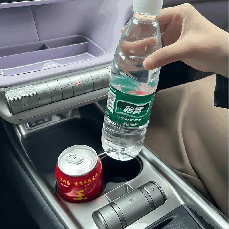 Custom-fit car center console cup holder organizer with a clear water bottle and red soda can.