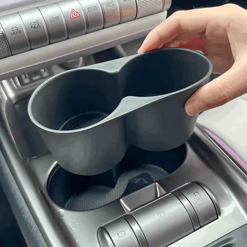 Matte black dual-compartment car cup holder organizer for BYD interior.