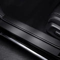 Black matte finish door sill protector with polished chrome trim for car interior protection.