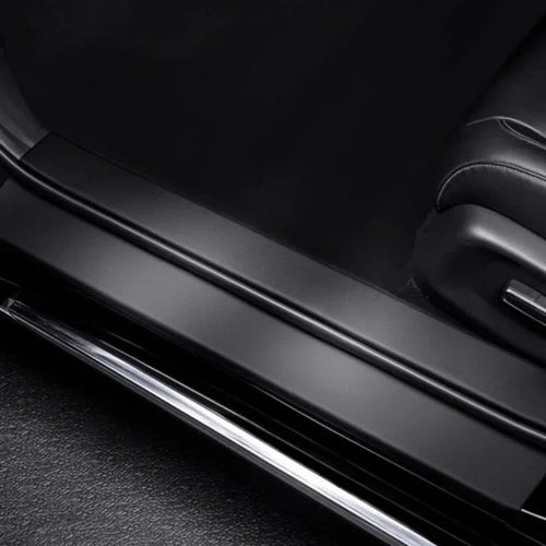 Black matte finish door sill protector with polished chrome trim for car interior protection.