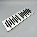 Silver brushed aluminum car accessory plate with decorative slotted cutouts.