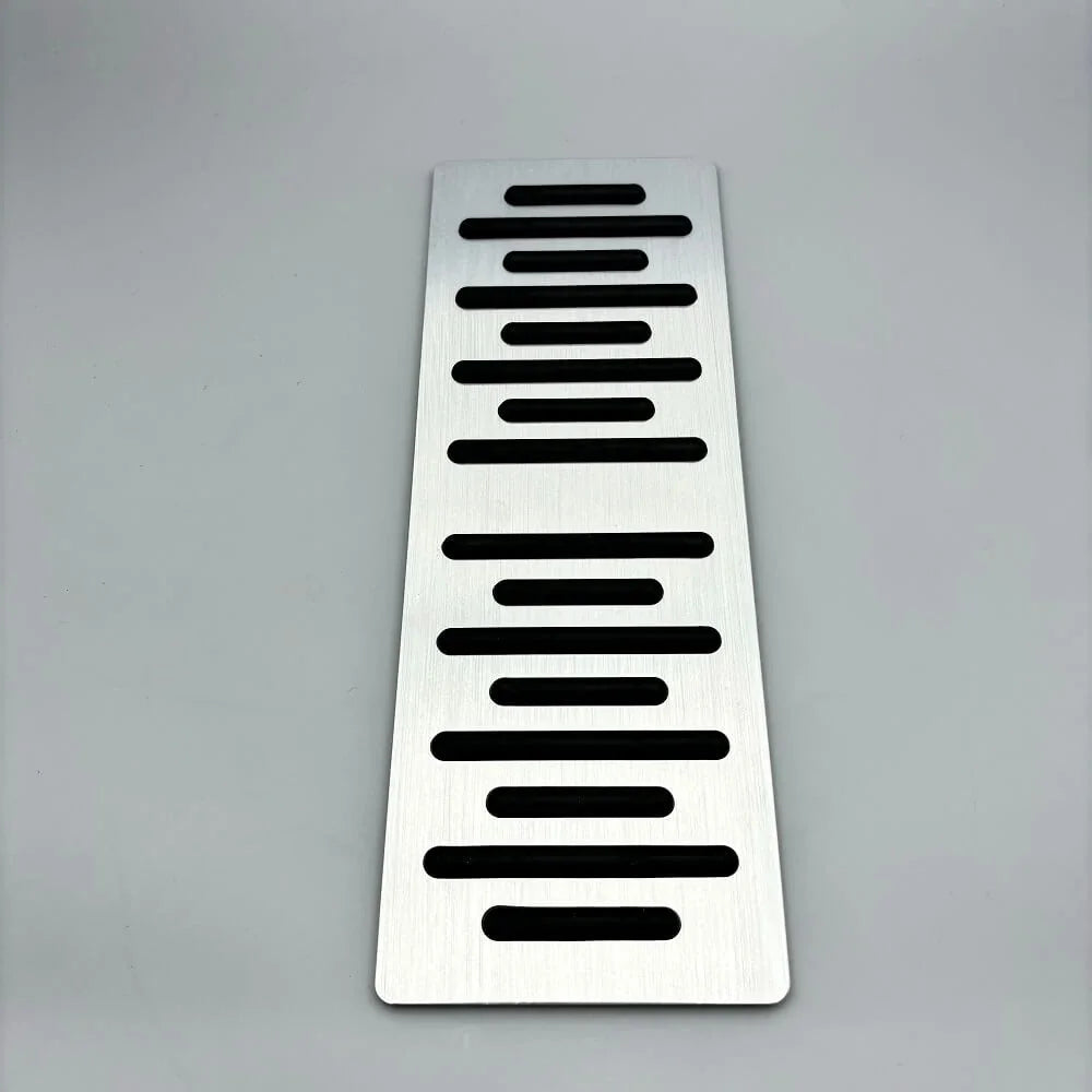 Silver brushed aluminum car pedal plate with black horizontal anti-slip grooves