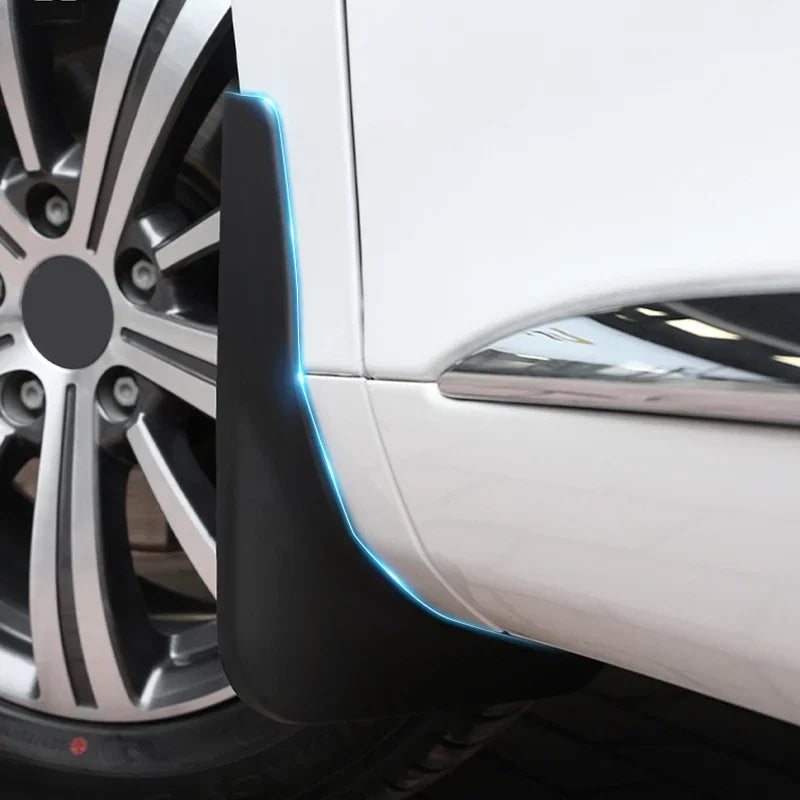 Close-up of a professional matte black plastic car mudguard installed on a white vehicle.