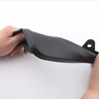 Hand holding a flexible, matte black plastic automotive accessory part