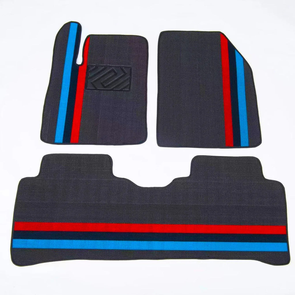 Dark grey custom car floor mats featuring distinctive red and blue racing stripes.