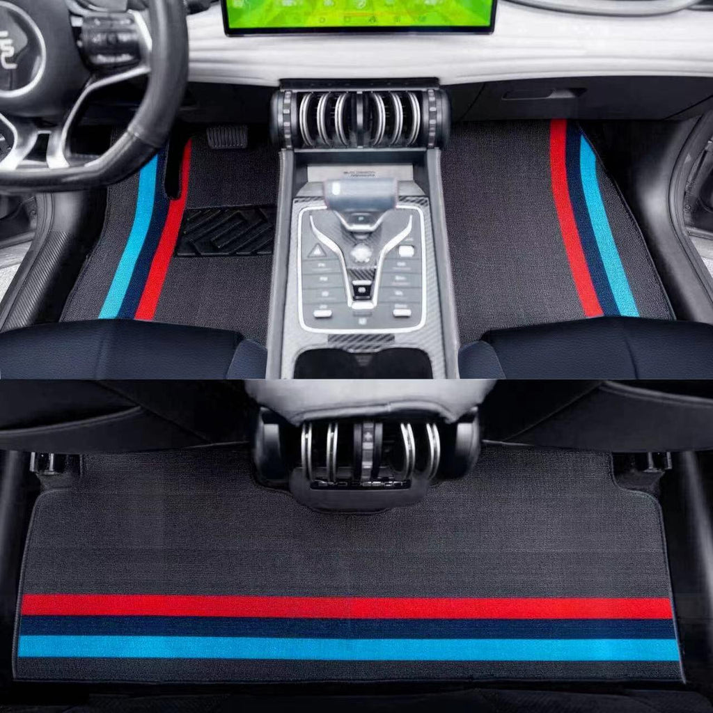 Black fabric car floor mats featuring distinctive red and blue racing stripes for BYD interior.