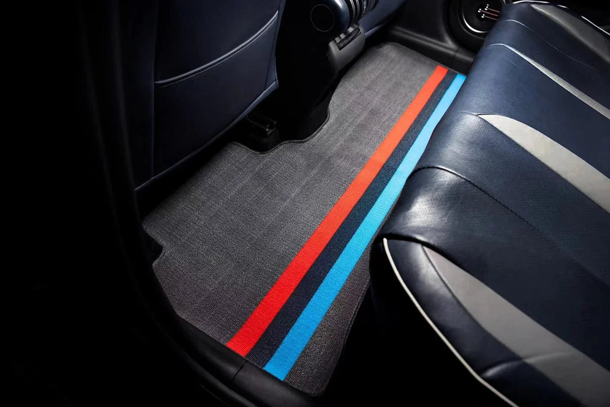 Grey fabric car floor mat with sporty red and blue racing stripes for BYD interior protection.
