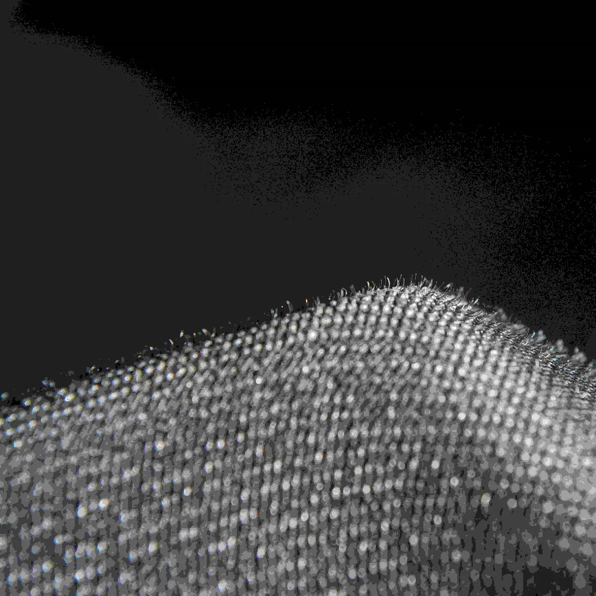 High-quality black textured fabric material with a fine, durable weave pattern.