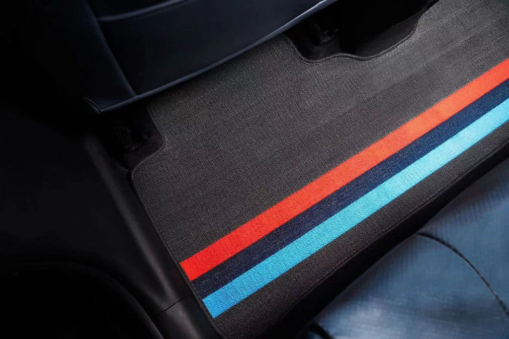 Custom dark grey fabric car floor mat featuring vibrant red and blue racing stripes.