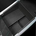 Black silicone car center console organizer tray with non-slip ribbed texture.