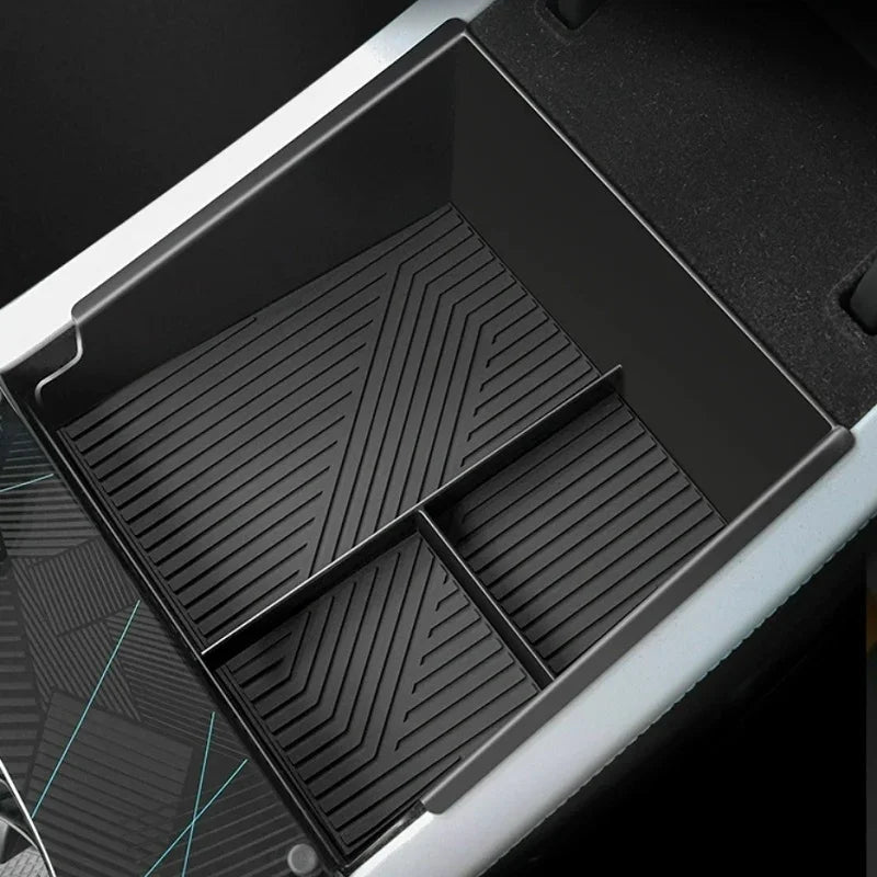 Black silicone car center console organizer tray with non-slip ribbed texture.