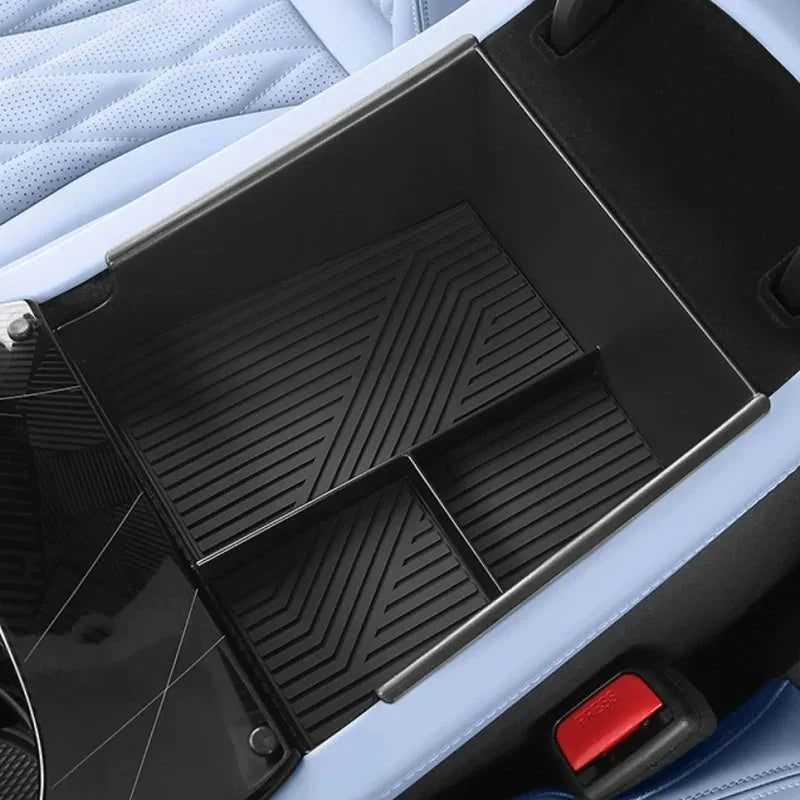 Black ribbed organizer tray for car center console in a light blue interior
