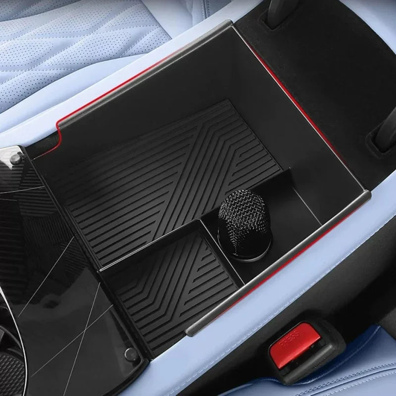 Black textured center console organizer tray with red trim for BYD vehicle interiors.