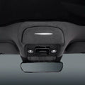 Grey fabric car interior ceiling featuring a sleek LED light strip and rearview mirror.