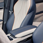 Two-tone blue and cream leather car seat with orange stitching and premium textured finish.