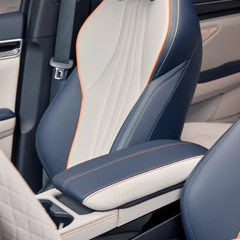 Two-tone blue and cream leather car seat with orange stitching and premium textured finish.