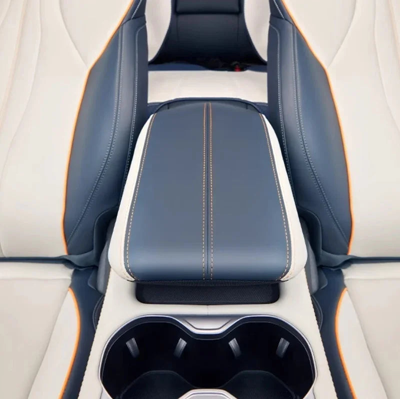 Premium blue and white leather car center console with orange contrast stitching.