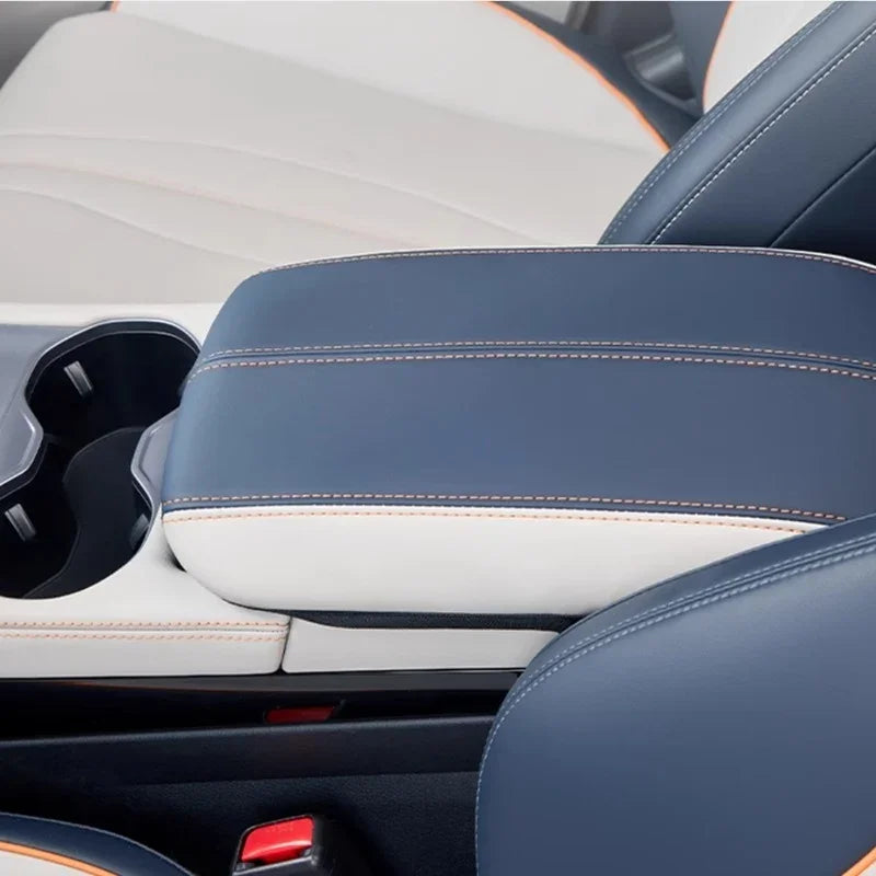 Premium two-tone blue and white leather car center console armrest with orange contrast stitching.