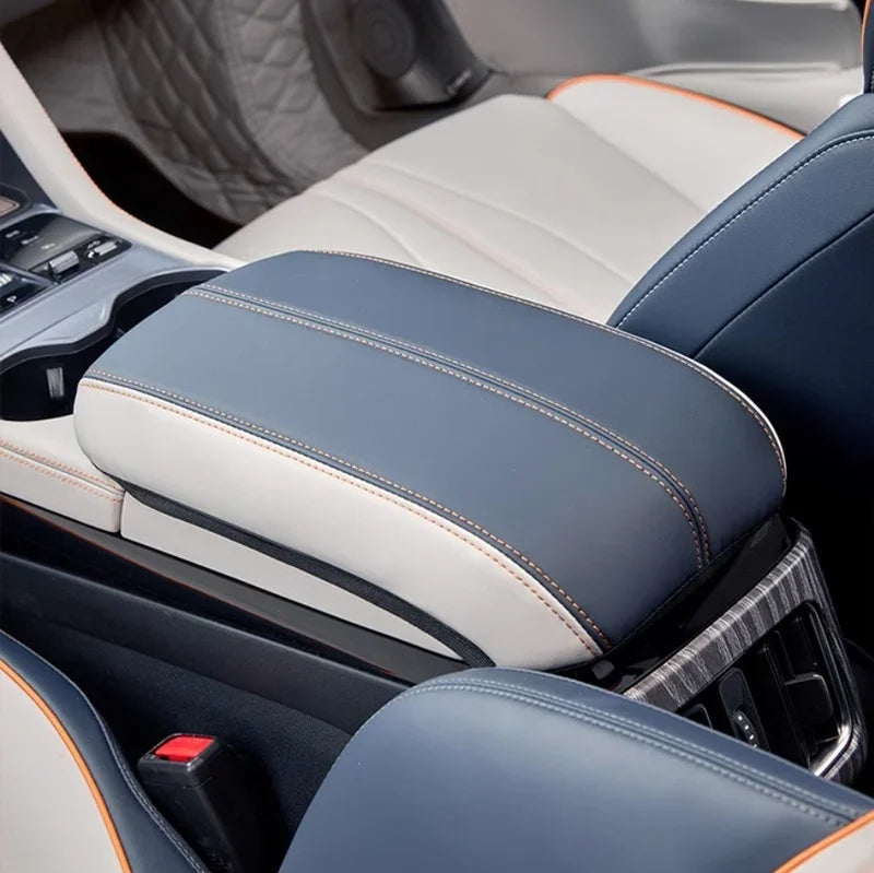 Premium blue and white leather car center console armrest with orange contrast stitching.