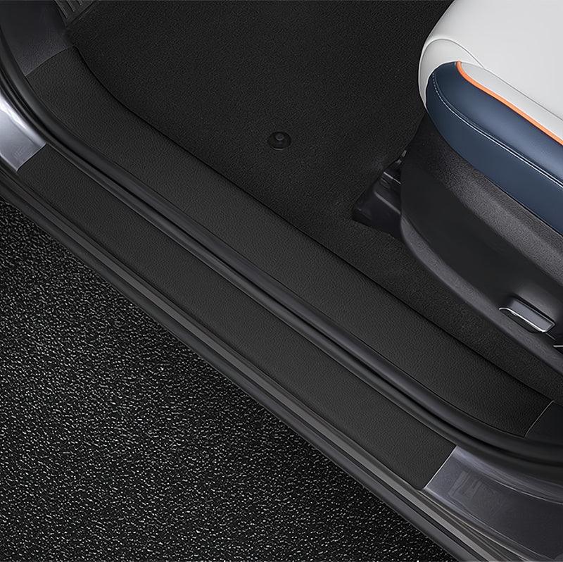 Black leather door sill protector for BYD car interior, durable and waterproof material.