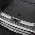 Silver textured metal rear bumper protector installed on a black car trunk sill