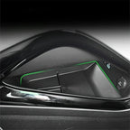 Black glossy center console storage tray with vibrant green ambient lighting for BYD cars.