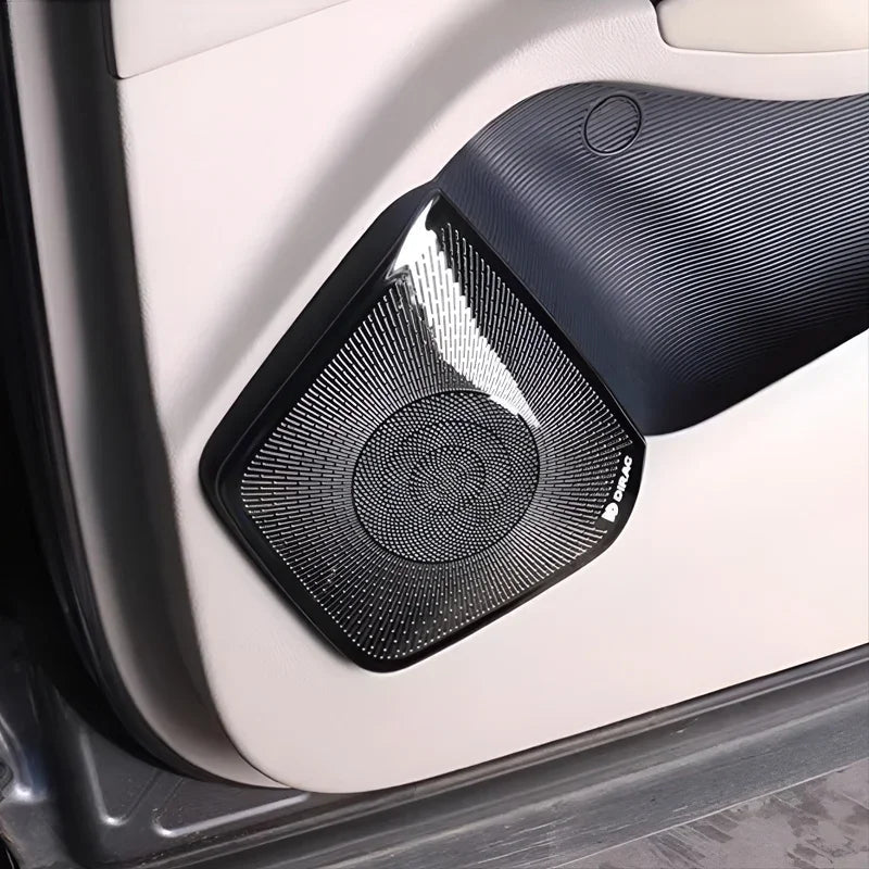 Black textured mesh speaker grille cover for BYD car door panel.