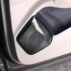 Black textured mesh speaker grille cover for BYD car door panel.