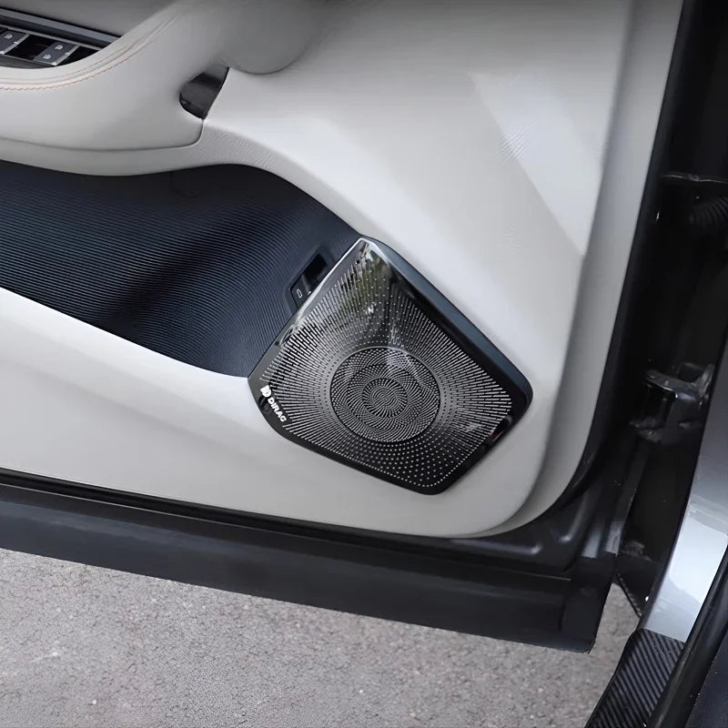Premium black Dirac car door speaker with a textured metallic mesh grille on a white interior panel.