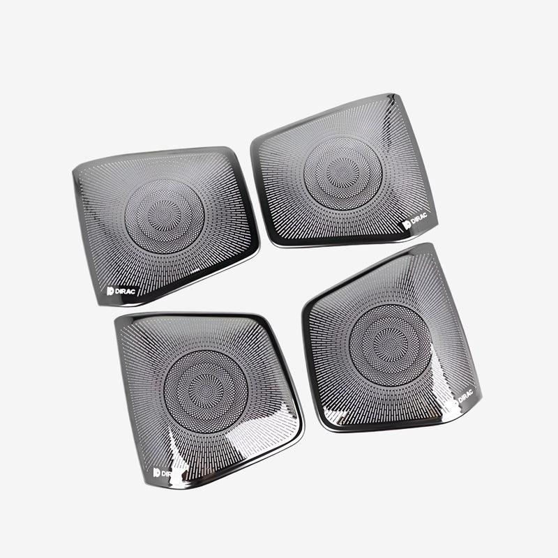 Set of four premium black metallic speaker grilles with a concentric circular pattern.
