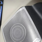 Silver metallic patterned speaker grille with a black textured surround for BYD interior.