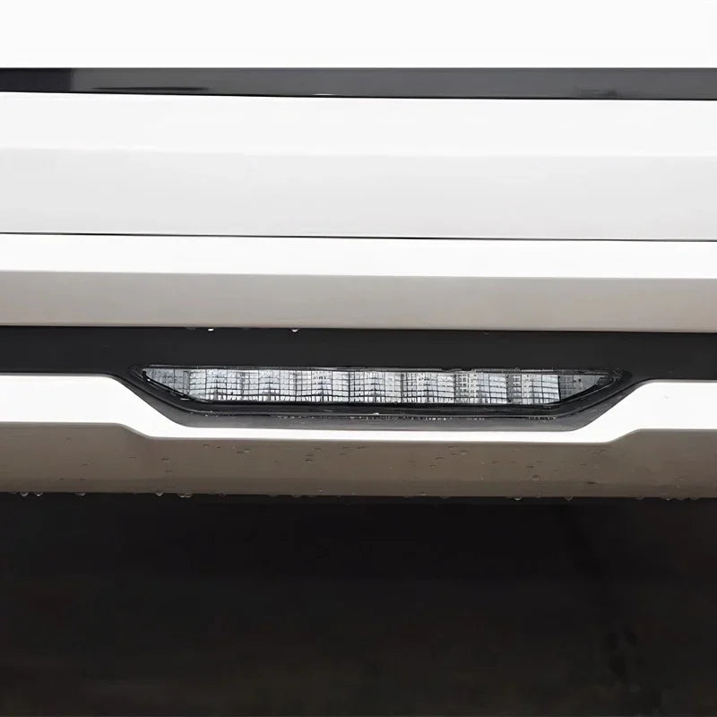 Sleek silver bumper with integrated LED daytime running light strip in a black housing.