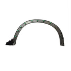 Black plastic curved wheel arch liner with green mounting clips for automotive protection