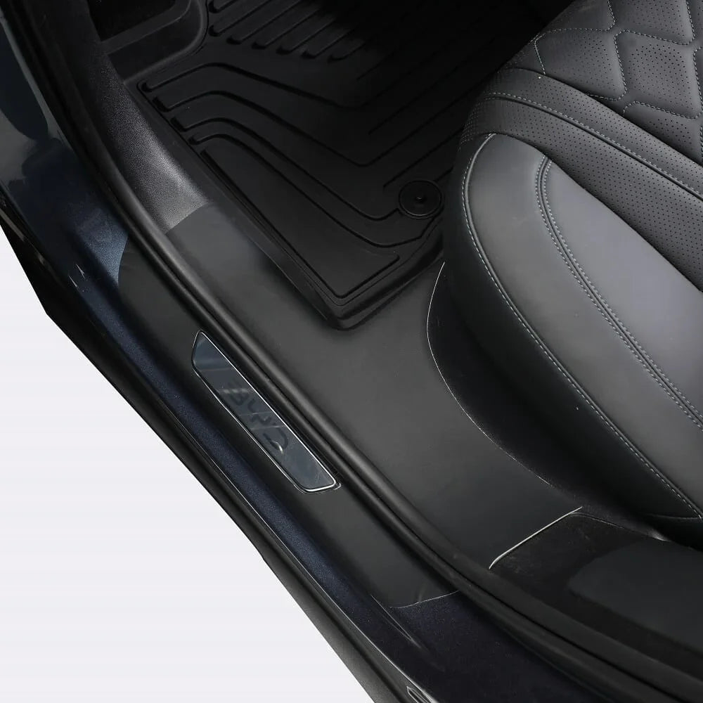 Black leather quilted car seat and durable black rubber floor mats for BYD protection.